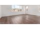 Bright bedroom with hardwood floors and a large window overlooking the neighborhood at 5744 E Lowden Rd, Cave Creek, AZ 85331