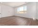 Bright and airy bedroom with hardwood floors and a large window with neighborhood views at 5744 E Lowden Rd, Cave Creek, AZ 85331