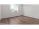 Bright bedroom with wood floors, a large window, and fresh, white walls at 5744 E Lowden Rd, Cave Creek, AZ 85331