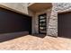 Modern home entrance showcasing a brick driveway, garage doors, and a glass-paneled front door at 5744 E Lowden Rd, Cave Creek, AZ 85331