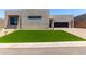 Contemporary home showcasing an artificial lawn, desert landscaping, and a brick driveway at 5744 E Lowden Rd, Cave Creek, AZ 85331