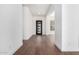 Bright hallway with hardwood floors and a contemporary black door at 5744 E Lowden Rd, Cave Creek, AZ 85331