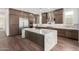 Modern kitchen with a large island featuring white marble countertops and stainless steel appliances at 5744 E Lowden Rd, Cave Creek, AZ 85331