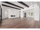 Spacious living room with hardwood floors, modern fireplace, and dark wood beam accents at 5744 E Lowden Rd, Cave Creek, AZ 85331