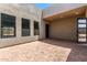 A covered patio featuring modern lighting, brick flooring, and large windows at 5744 E Lowden Rd, Cave Creek, AZ 85331