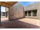 Spacious outdoor living area featuring brick flooring and access to the home's interior at 5744 E Lowden Rd, Cave Creek, AZ 85331