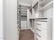 Spacious walk-in closet with custom shelving, drawers, and hardwood floors at 5744 E Lowden Rd, Cave Creek, AZ 85331