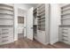 Well-organized walk-in closet with built-in shelves, drawers, and wood flooring at 5744 E Lowden Rd, Cave Creek, AZ 85331