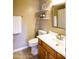 Cozy powder room featuring a single sink vanity and convenient shelving for toiletries and decor at 7156 S Forest Ave, Gilbert, AZ 85298