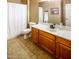 Clean bathroom with a vanity, tile floor, and a shower behind a white curtain at 7156 S Forest Ave, Gilbert, AZ 85298