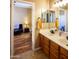 Double vanity bathroom with warm paint, tile floor and a view into the room next door at 7156 S Forest Ave, Gilbert, AZ 85298