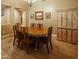Traditional dining room with a wooden table set for six, chandelier lighting, and beautiful wall art at 7156 S Forest Ave, Gilbert, AZ 85298