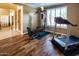 Dedicated workout area with wood floors, large window, and home gym equipment for convenient exercise at 7156 S Forest Ave, Gilbert, AZ 85298