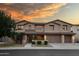 Gorgeous two-story home featuring well manicured landscaping, a two car garage, and beautiful desert sunset skies at 7156 S Forest Ave, Gilbert, AZ 85298