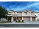 This gorgeous two-story home features well manicured landscaping and a two-car garage, highlighted by clear blue skies at 7156 S Forest Ave, Gilbert, AZ 85298