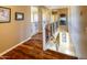 Bright hallway with hardwood floors, an ornamental railing, and neutral paint at 7156 S Forest Ave, Gilbert, AZ 85298