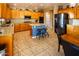 Spacious kitchen features wooden cabinetry, granite countertops, a central island, and stainless steel appliances at 7156 S Forest Ave, Gilbert, AZ 85298