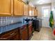 Laundry room with wooden cabinets, a stylish backsplash, and modern appliances at 7156 S Forest Ave, Gilbert, AZ 85298