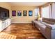 Comfortable living room with a sectional sofa, entertainment center, and decorative movie posters at 7156 S Forest Ave, Gilbert, AZ 85298