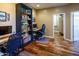 Bright home office with wood floors and a spacious desk area, perfect for working or studying from home at 7156 S Forest Ave, Gilbert, AZ 85298