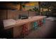 Outdoor kitchen with a built-in grill, counter space, sink and bar stool seating at 7156 S Forest Ave, Gilbert, AZ 85298