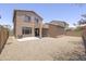 The backyard offers a mix of patio space and gravel, enclosed by block wall fencing for privacy at 7227 E Northridge St, Mesa, AZ 85207