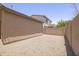 The exterior shows a gravel backyard with block wall fencing and neighboring houses in the distance at 7227 E Northridge St, Mesa, AZ 85207