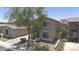 Two-story home featuring a tile roof, a well-maintained lawn, a large tree, and an attached garage at 7227 E Northridge St, Mesa, AZ 85207