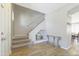 Welcoming foyer featuring wood flooring, a staircase, and elegant glass table at 7227 E Northridge St, Mesa, AZ 85207