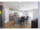 This kitchen features stainless steel appliances, an island with barstool seating, and modern lighting fixtures at 7227 E Northridge St, Mesa, AZ 85207