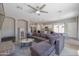 Cozy living room with sectional, ceiling fan, view into the kitchen, and open concept layout at 7227 E Northridge St, Mesa, AZ 85207