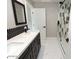 Bathroom features dual sinks with black hardware, decorative backsplash, and a sleek glass-enclosed shower at 7840 N 7Th St # 15, Phoenix, AZ 85020