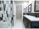 Bathroom features dual sinks with black hardware, decorative backsplash, and a sleek glass-enclosed shower at 7840 N 7Th St # 15, Phoenix, AZ 85020