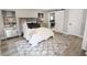 Bedroom with stylish décor, including a plush bed, unique artwork, and a sliding barn door leading to bath at 7840 N 7Th St # 15, Phoenix, AZ 85020