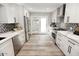 Stylish kitchen with stainless steel appliances, modern backsplash, and white countertops at 7840 N 7Th St # 15, Phoenix, AZ 85020