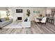 Bright, open living area with wood floors, fireplace, and neutral-colored furniture at 7840 N 7Th St # 15, Phoenix, AZ 85020