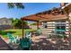Relaxing back patio with a pergola, string lights, and outdoor seating, perfect for entertaining guests at 925 W Hudson Way, Gilbert, AZ 85233