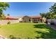 Expansive backyard with well-maintained lawn, patio, and privacy fence, ideal for outdoor gatherings at 925 W Hudson Way, Gilbert, AZ 85233