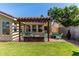 Outdoor patio with pergola and green chairs set in the backyard area at 925 W Hudson Way, Gilbert, AZ 85233