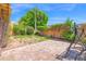 Backyard with grass and brick tile and mature landscaping and an old swing set at 1040 E Clinton St, Phoenix, AZ 85020