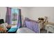 Bedroom with a twin bed, large window with curtains, and comfortable upholstered arm chair at 1040 E Clinton St, Phoenix, AZ 85020