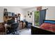 Bedroom with a desk, bookshelves, and a window view of the outdoor landscaping at 1040 E Clinton St, Phoenix, AZ 85020