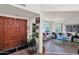 Inviting entryway with a beautiful wood door leading to a bright living room, showcasing a welcoming and stylish home at 1040 E Clinton St, Phoenix, AZ 85020