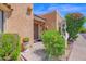 Close-up of the front door featuring desert landscaping and lush bougainvillea at 1040 E Clinton St, Phoenix, AZ 85020