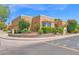 Inviting corner lot home with lush landscaping, flowers, and brick accents showcasing desert charm at 1040 E Clinton St, Phoenix, AZ 85020