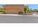 View of the two car garage nestled in desert landscaping at 1040 E Clinton St, Phoenix, AZ 85020