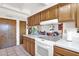 Well-organized kitchen with wood cabinets and an electric cooktop, creating a space for culinary creativity at 1040 E Clinton St, Phoenix, AZ 85020