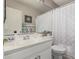 Clean bathroom with a vanity, mirror, and shower featuring a patterned white curtain at 10852 E Contessa St, Mesa, AZ 85207