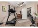 Bedroom featuring a treadmill, ceiling fan, and access to additional rooms at 10852 E Contessa St, Mesa, AZ 85207