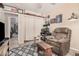 Comfortable bedroom with a telescope and recliner, creating a relaxing and inviting space at 10852 E Contessa St, Mesa, AZ 85207